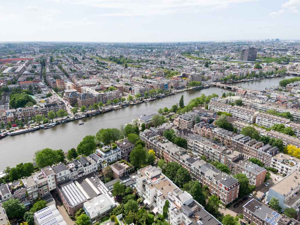 Luchtfoto van een kanaal omgeven door woonhuizen en andere gebouwen.